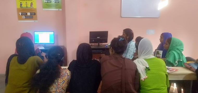 Learners gathered around a computer