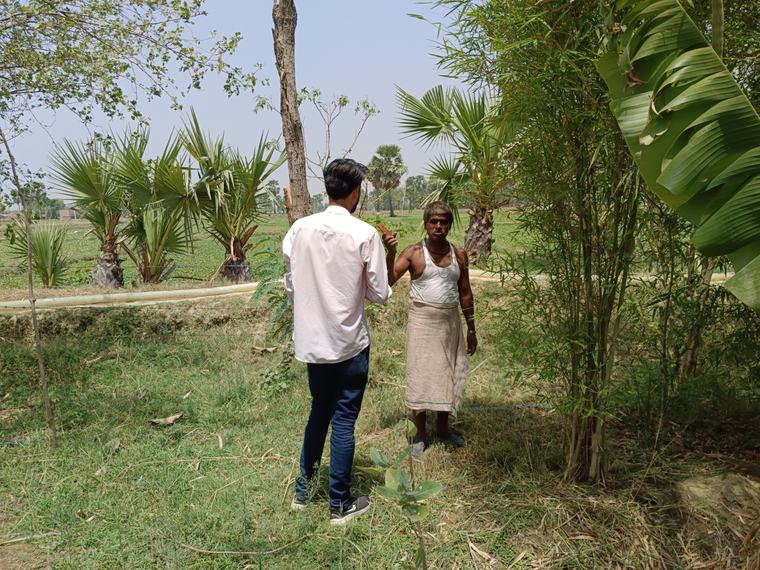 A fellow in conversation with a farmer