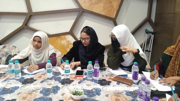 Fellows taking notes during a roundtable